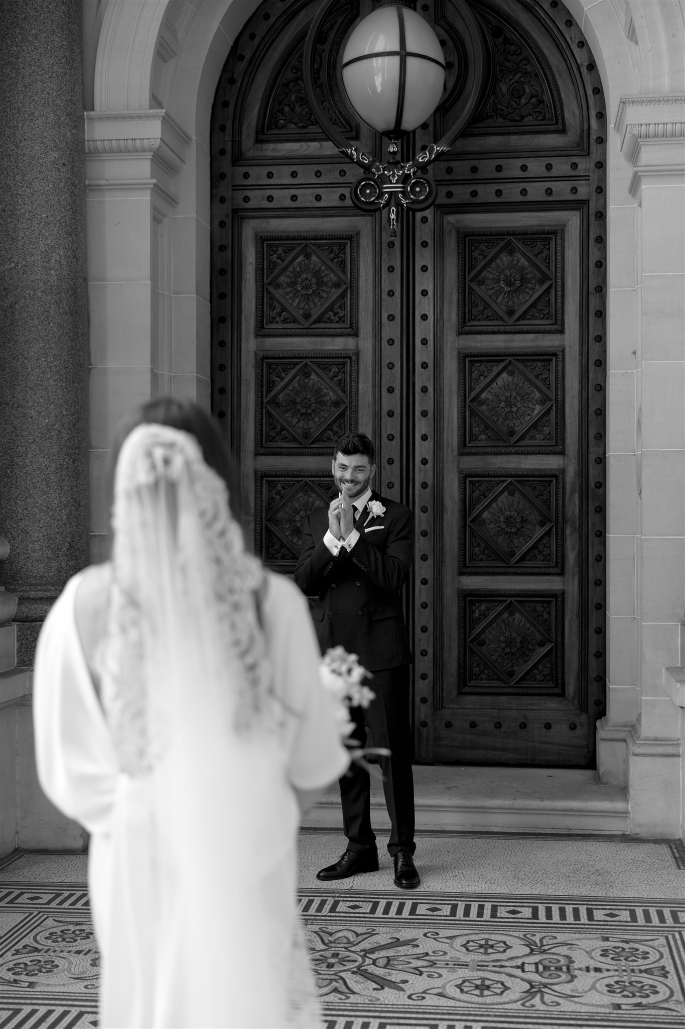 Stylish bride Lindsay in a Lola Varma dress and cowgirl boots, celebrating her Melbourne City elopement at the Melbourne Registry Office