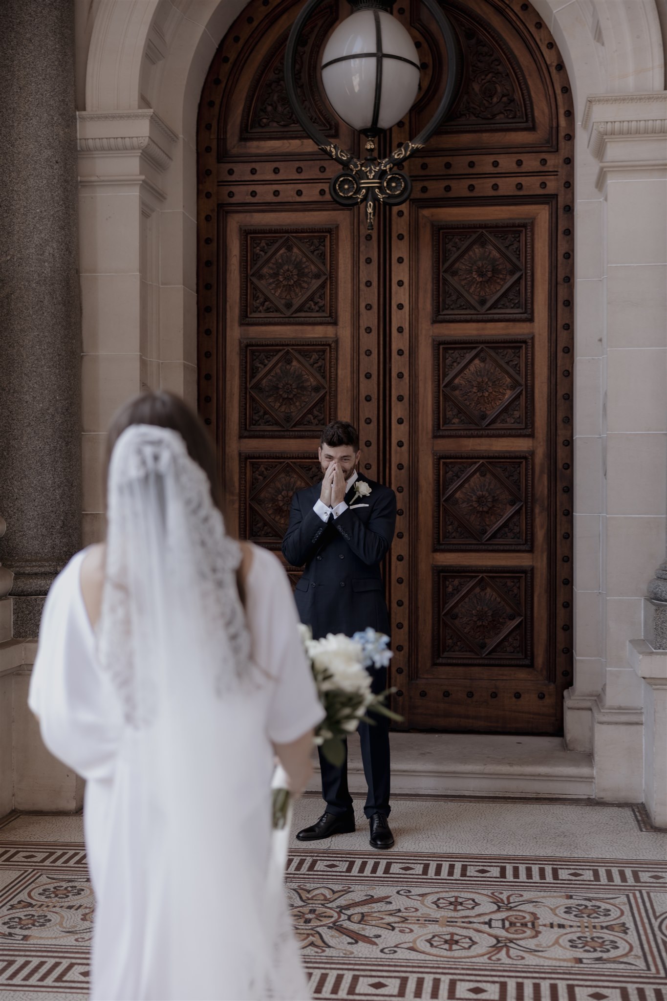 Stylish bride Lindsay in a Lola Varma dress and cowgirl boots, celebrating her Melbourne City elopement at the Melbourne Registry Office