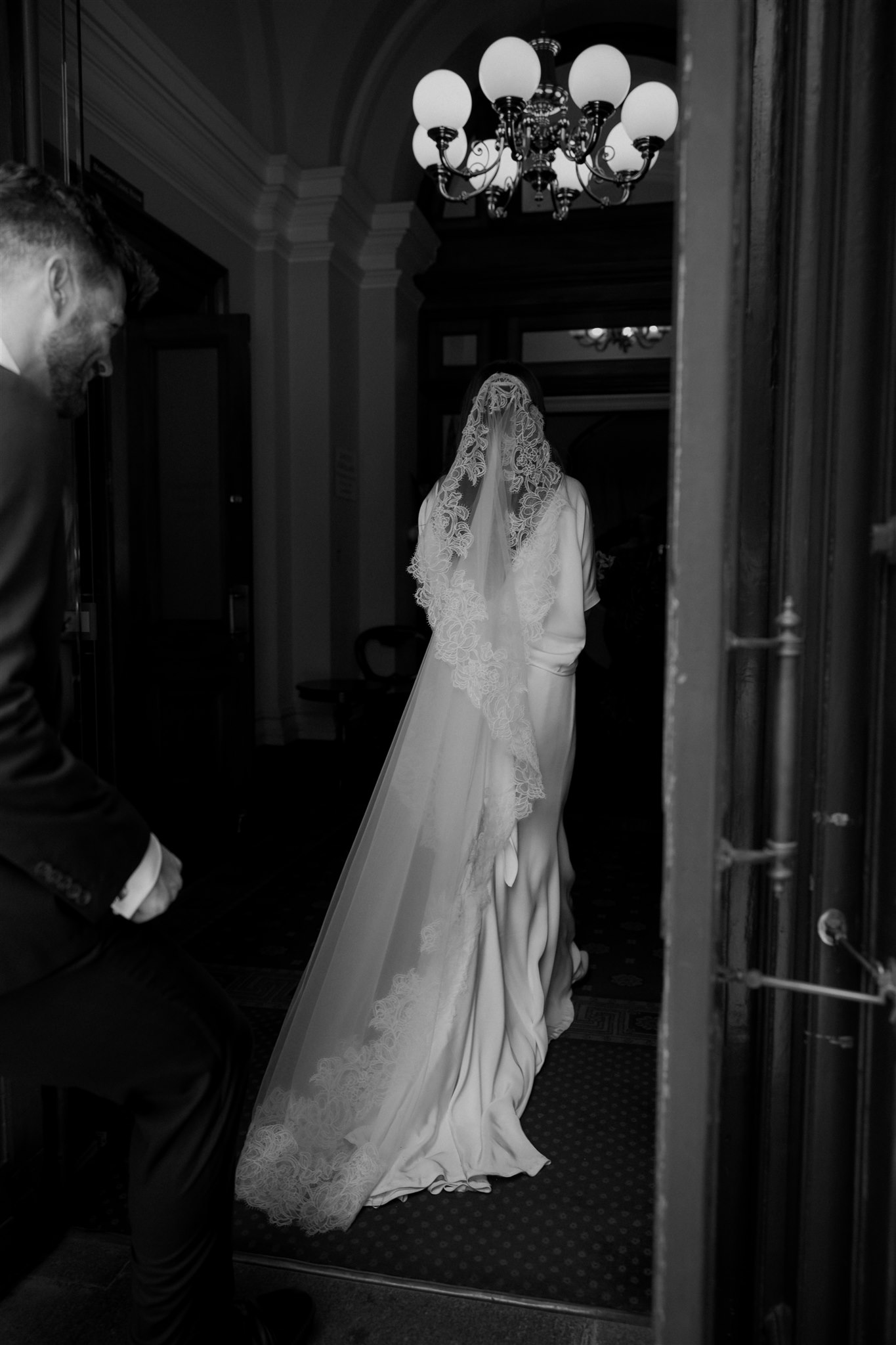 Stylish bride Lindsay in a Lola Varma dress and cowgirl boots, celebrating her Melbourne City elopement at the Melbourne Registry Office