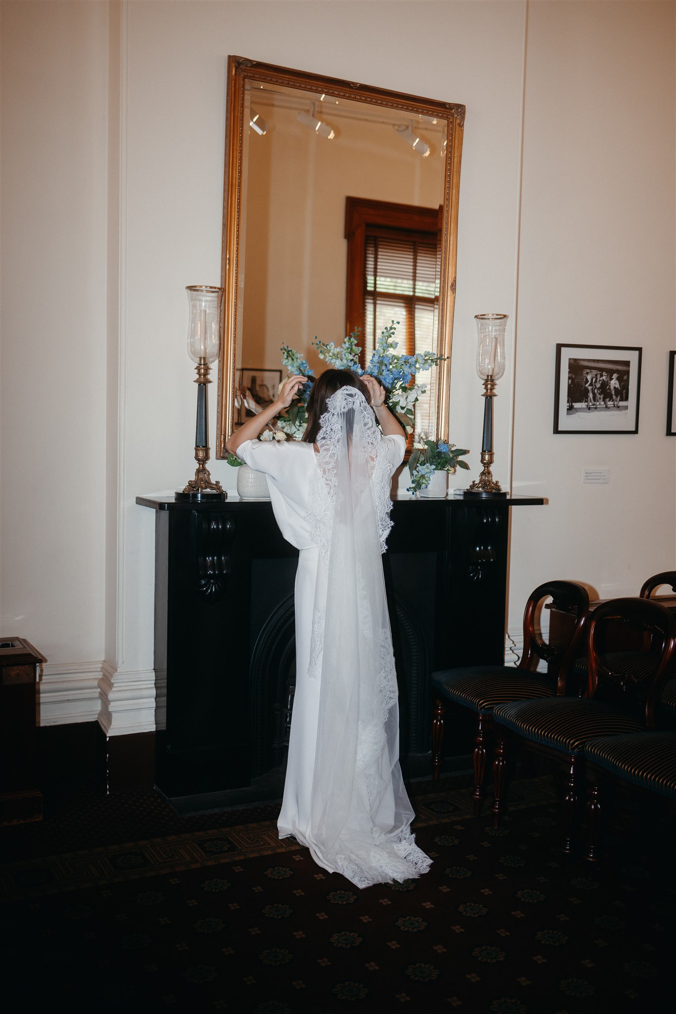 Stylish bride Lindsay in a Lola Varma dress and cowgirl boots, celebrating her Melbourne City elopement at the Melbourne Registry Office