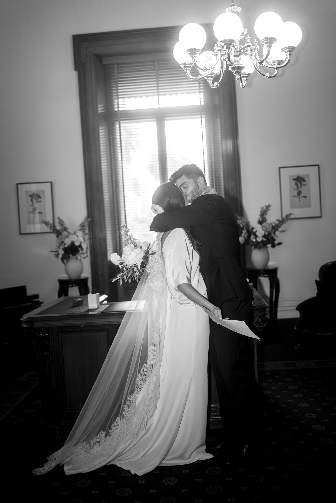 Stylish bride Lindsay in a Lola Varma dress and cowgirl boots, celebrating her Melbourne City elopement at the Melbourne Registry Office