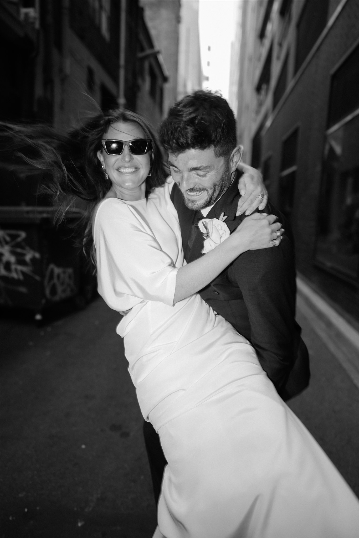 Stylish bride Lindsay in a Lola Varma dress and cowgirl boots, celebrating her Melbourne City elopement at the Melbourne Registry Office