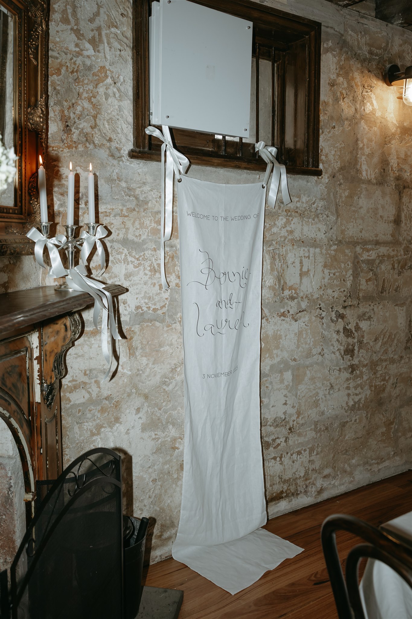 Unique wedding styling featuring bows, candles and premium linen signage