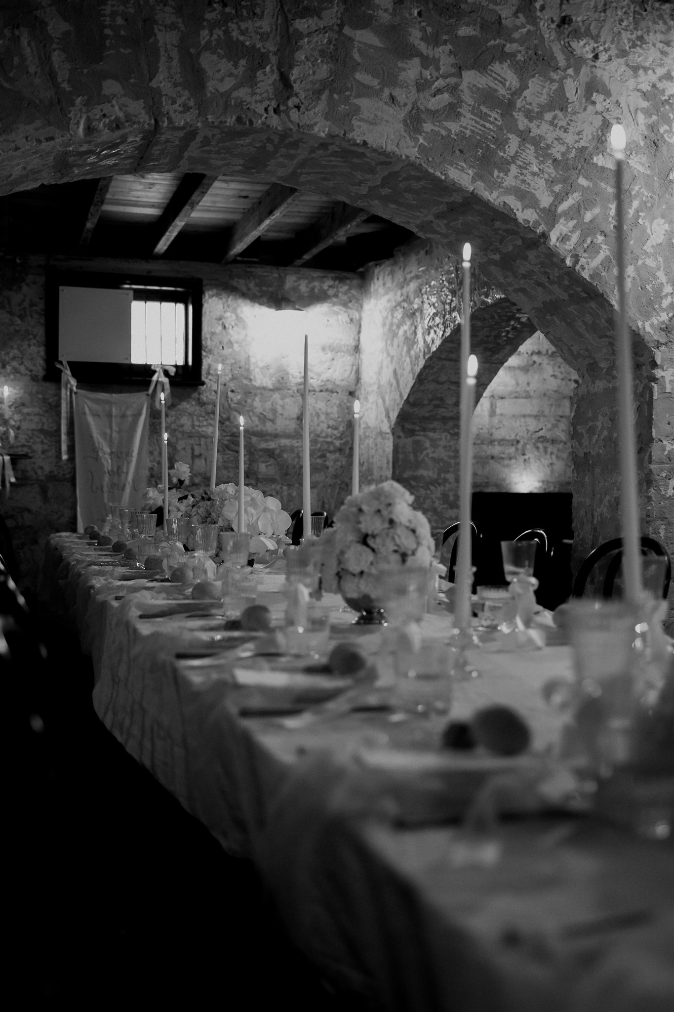 Elegant wedding styling with pearl-themed accents, premium linens, and vintage tableware at Lauren and Bernie’s romantic intimate wedding reception at Frolic Lane. Showcasing unique sandstone arches in the background. 35mm film wedding photography.