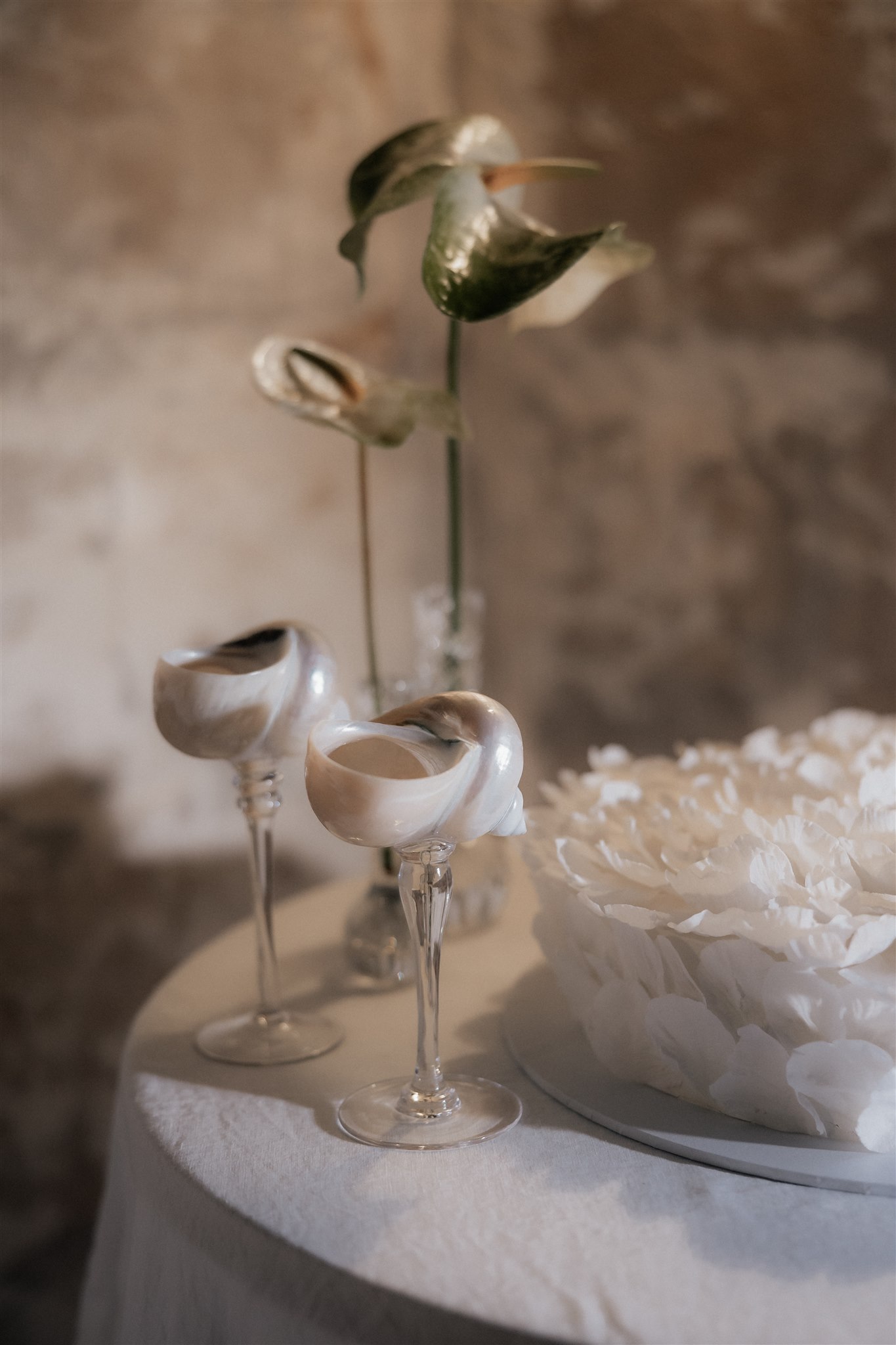 Elegant wedding styling with pearl-themed accents, premium linens, and vintage tableware at Lauren and Bernie’s romantic intimate wedding reception at Frolic Lane. Showcasing unique sandstone arches in the background. 35mm film wedding photography.