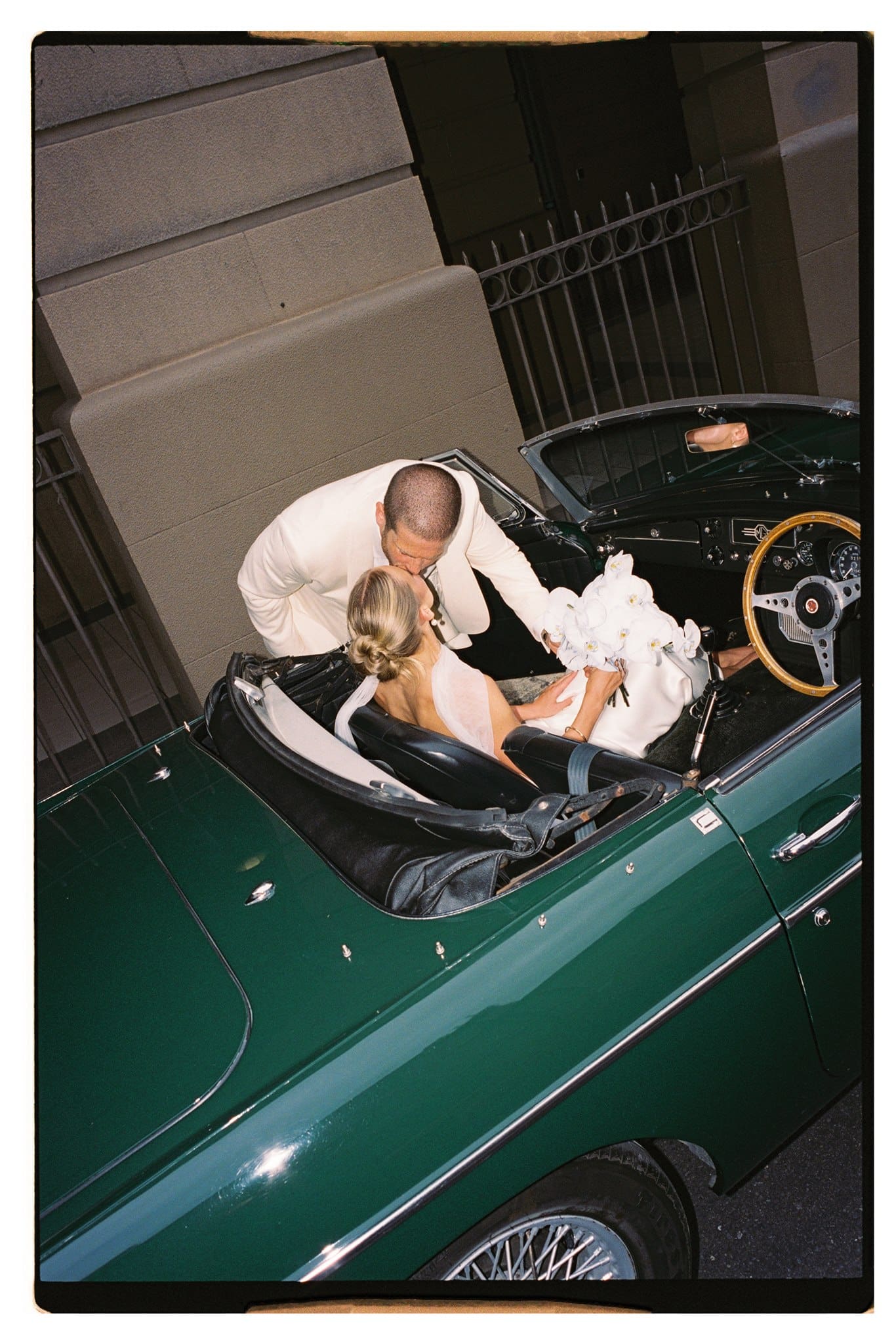 Georgina and Andrew Film photo of bride and groom and their wedding car in Adelaide